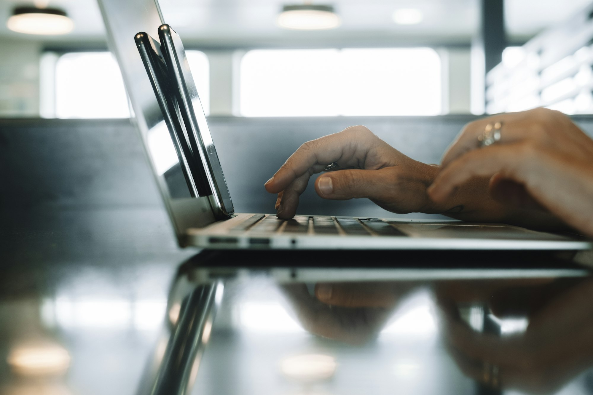 using computer.hand typing message on keyboard laptop chatting friend search information form